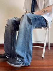 Men's distressed wide-leg jeans in blue denim with pockets and ankle pooling.