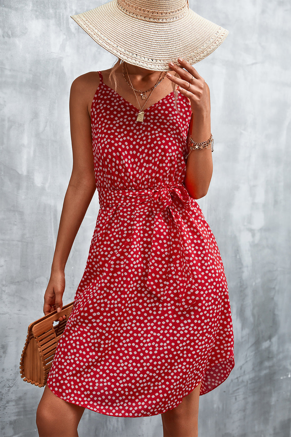 Red daisy print slip dress with tie waist, V-neck, and spaghetti straps.