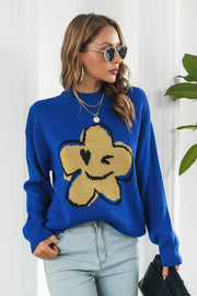 Royal blue acrylic sweater with a yellow smiley flower intarsia knit design and crew neck.