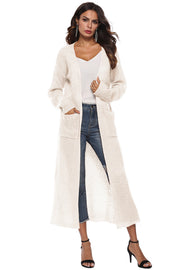 Ivory longline knit cardigan with pockets and side slits.