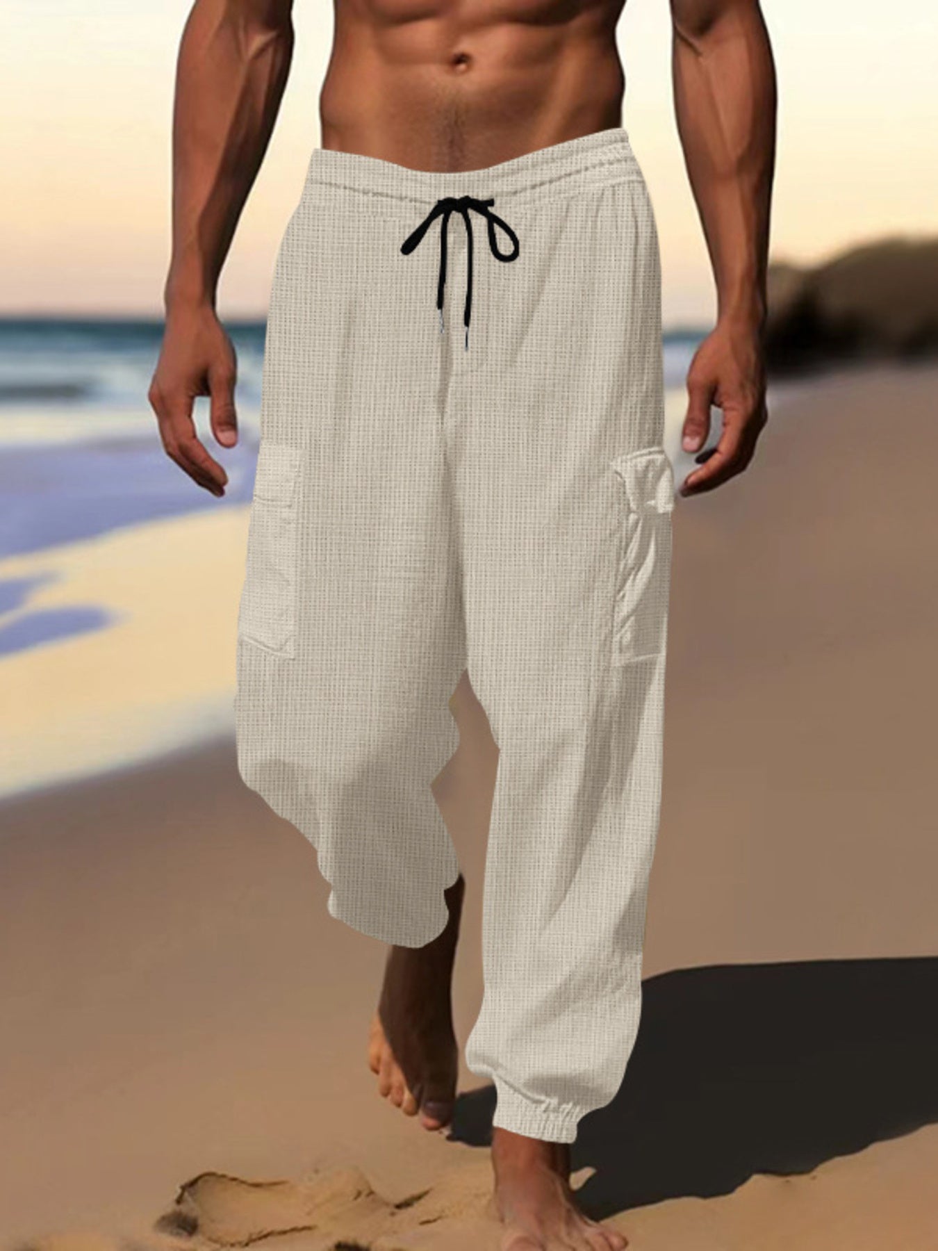 Men's light gray waffle knit joggers with drawstring and cargo pockets.