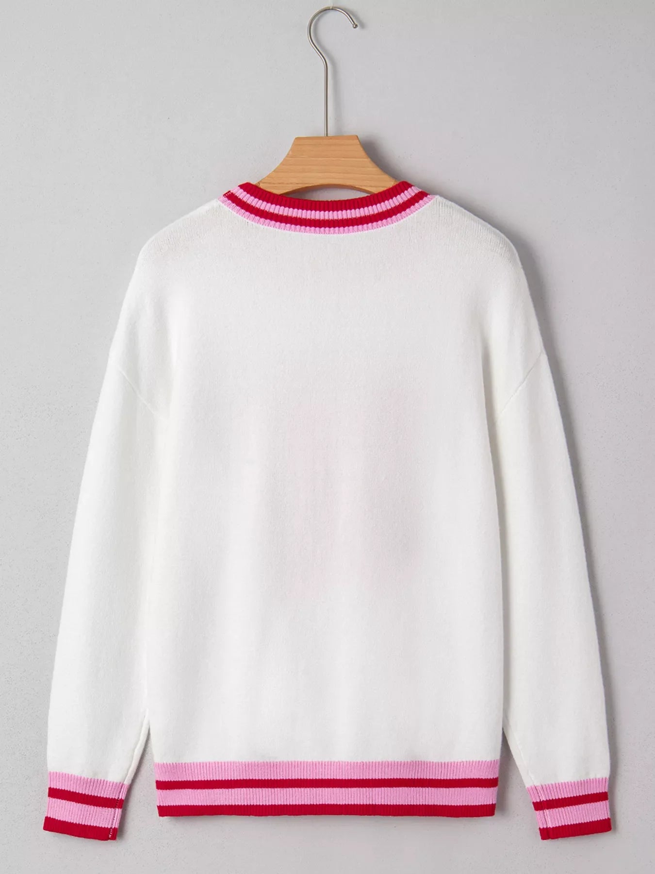 White round-neck sweater with striped ribbed collar, cuffs, and hem in pink and red.