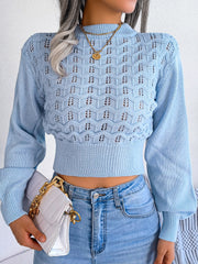 Pastel blue openwork knit sweater with puff sleeves and mock neck.