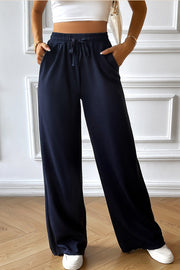 Dark blue textured rib wide-leg drawstring trousers with pockets.
