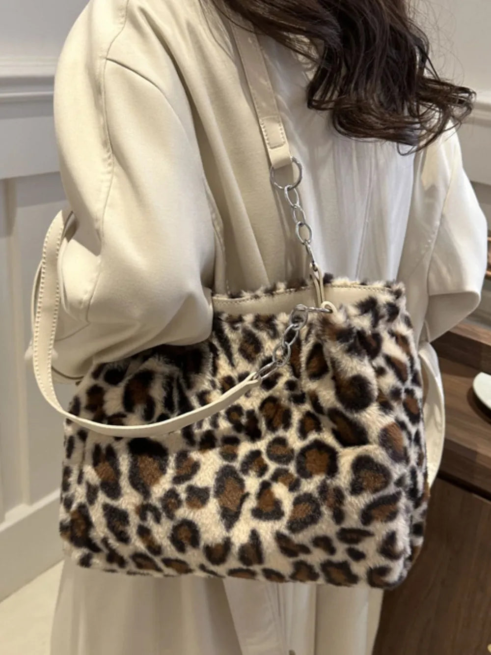 Leopard print faux fur shopper bag with chain handle and cream straps.