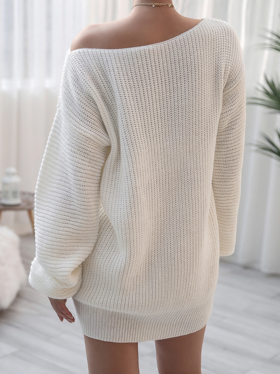 Off-shoulder ribbed knit mini dress in white acrylic with long sleeves and a casual cut.