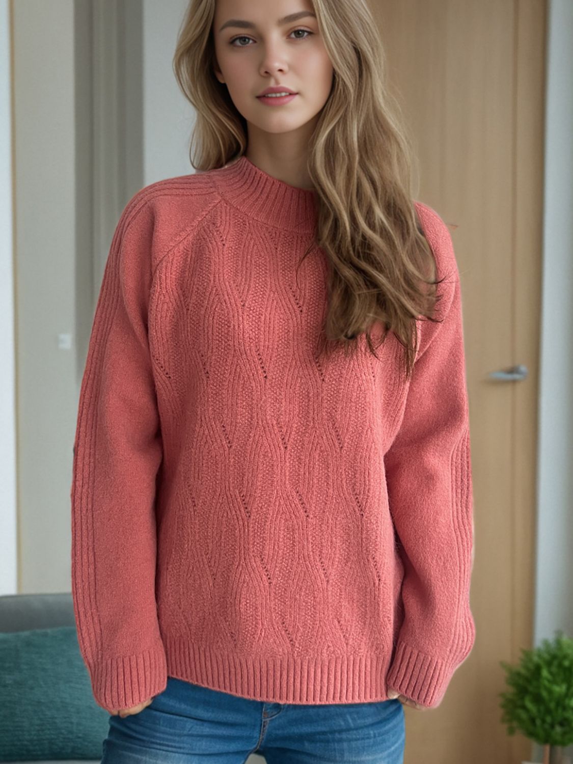 Textured knit raglan sleeve pullover in burnt coral with diamond pattern and mock neck.