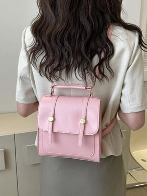 Chic PU leather mini backpack in blush pink with gold hardware and top handle.