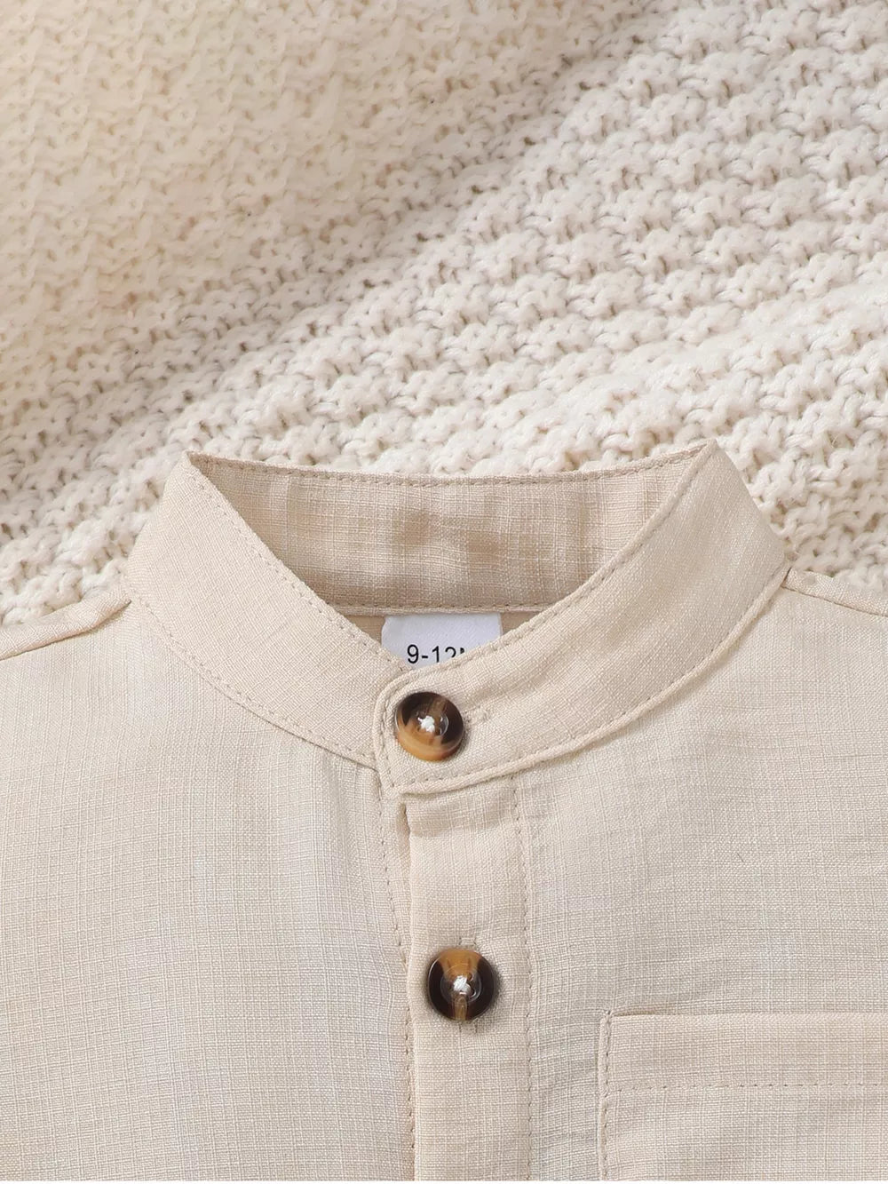 Beige linen blend baby shirt with mandarin collar and two button details.