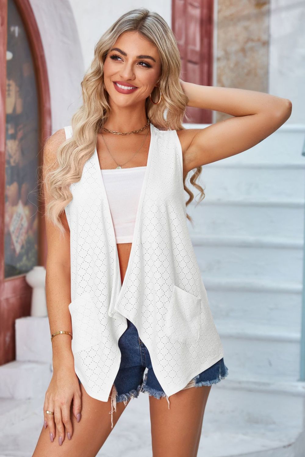 White eyelet drape front vest with pockets and open knit detail