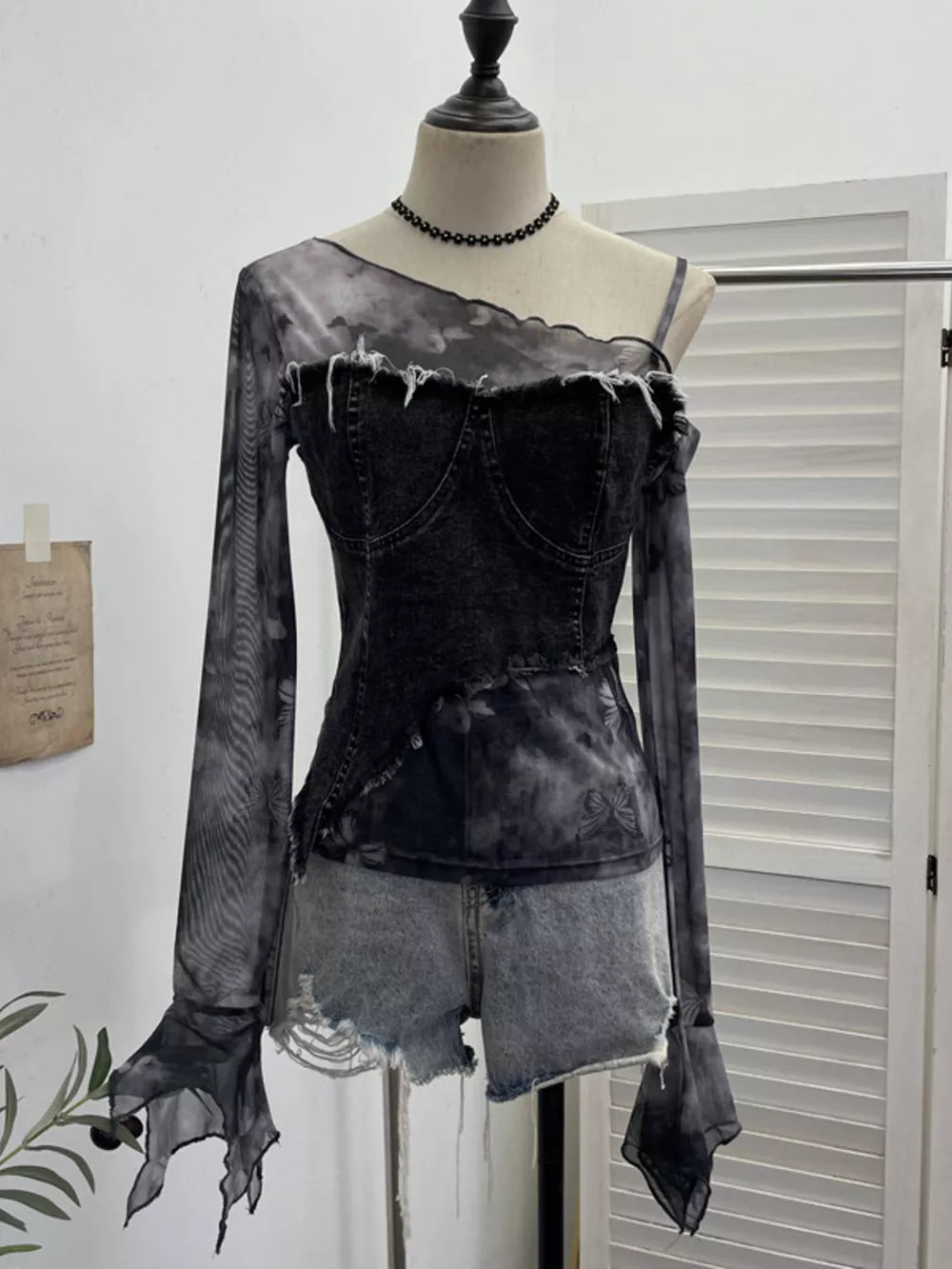 Edgy asymmetrical denim t-shirt with mesh sleeves and butterfly print in gray black.