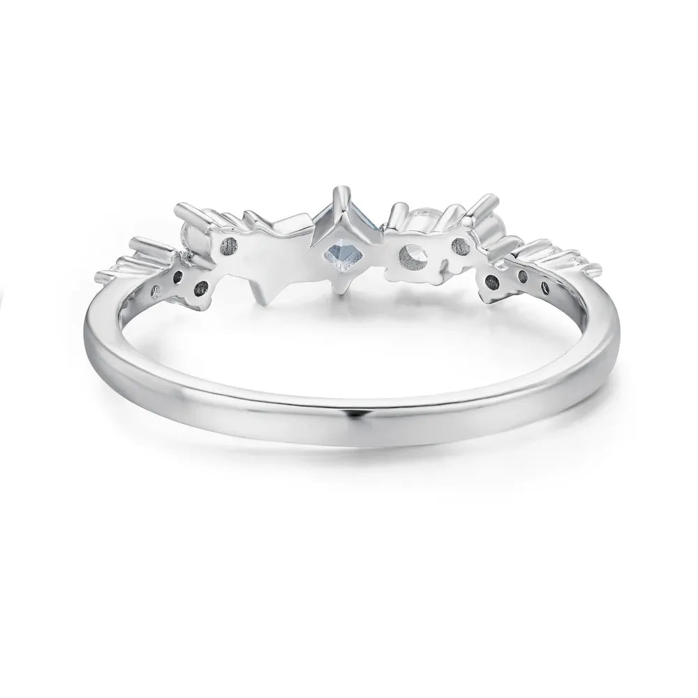 Silver celestial cluster ring with small clear stones and a central square-cut stone.