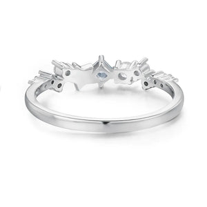 Silver celestial cluster ring with small clear stones and a central square-cut stone.
