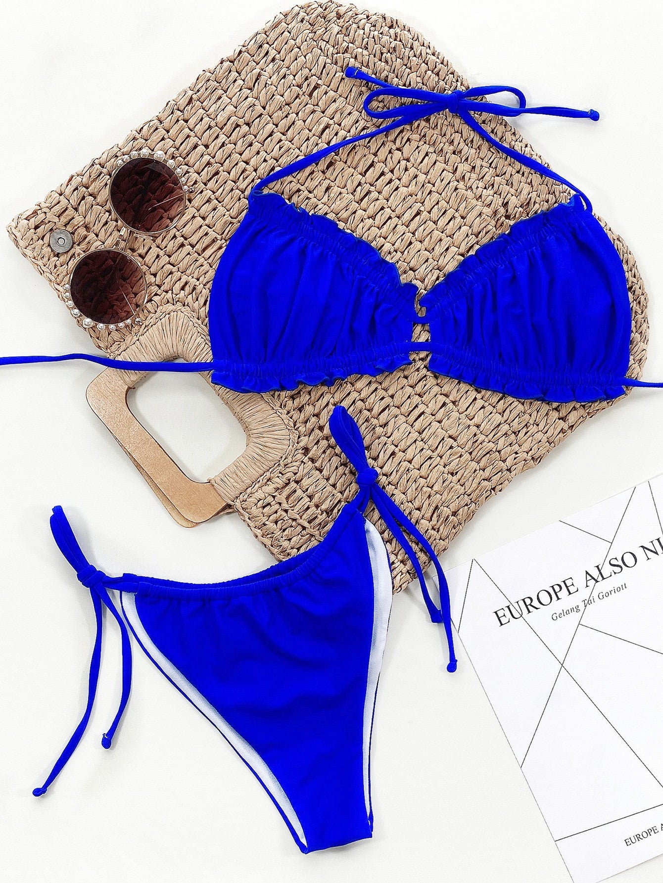 Royal blue bikini set with ruffled tie halter top and side tie bottoms.