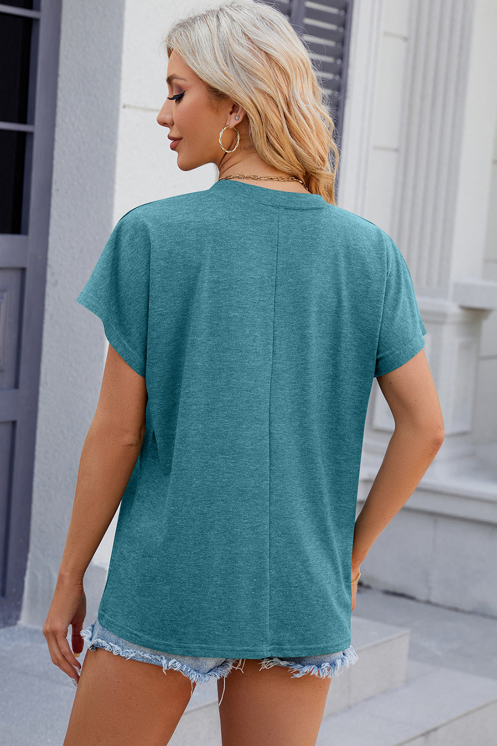 Turquoise dolman sleeve slouchy v-neck top with a relaxed fit.