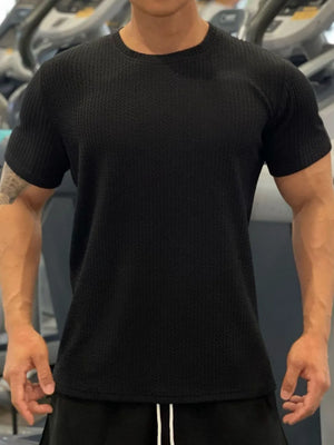 Black textured performance crew neck tee with short sleeves.