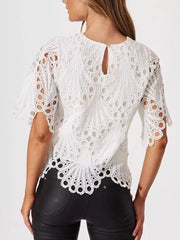 White lace half-sleeve blouse with intricate eyelet pattern and scalloped hem.