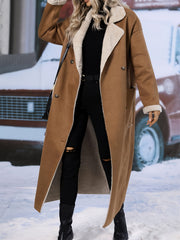 Brown reversible maxi coat with shearling trim and double-breasted closure.