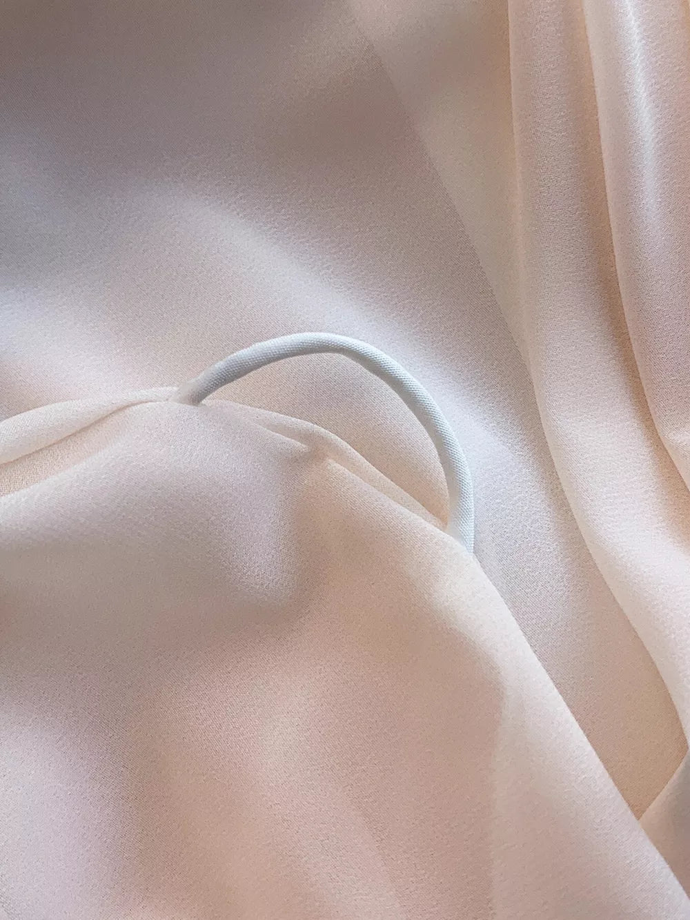 Light Pink off-shoulder dress detail with a white elastic strap.