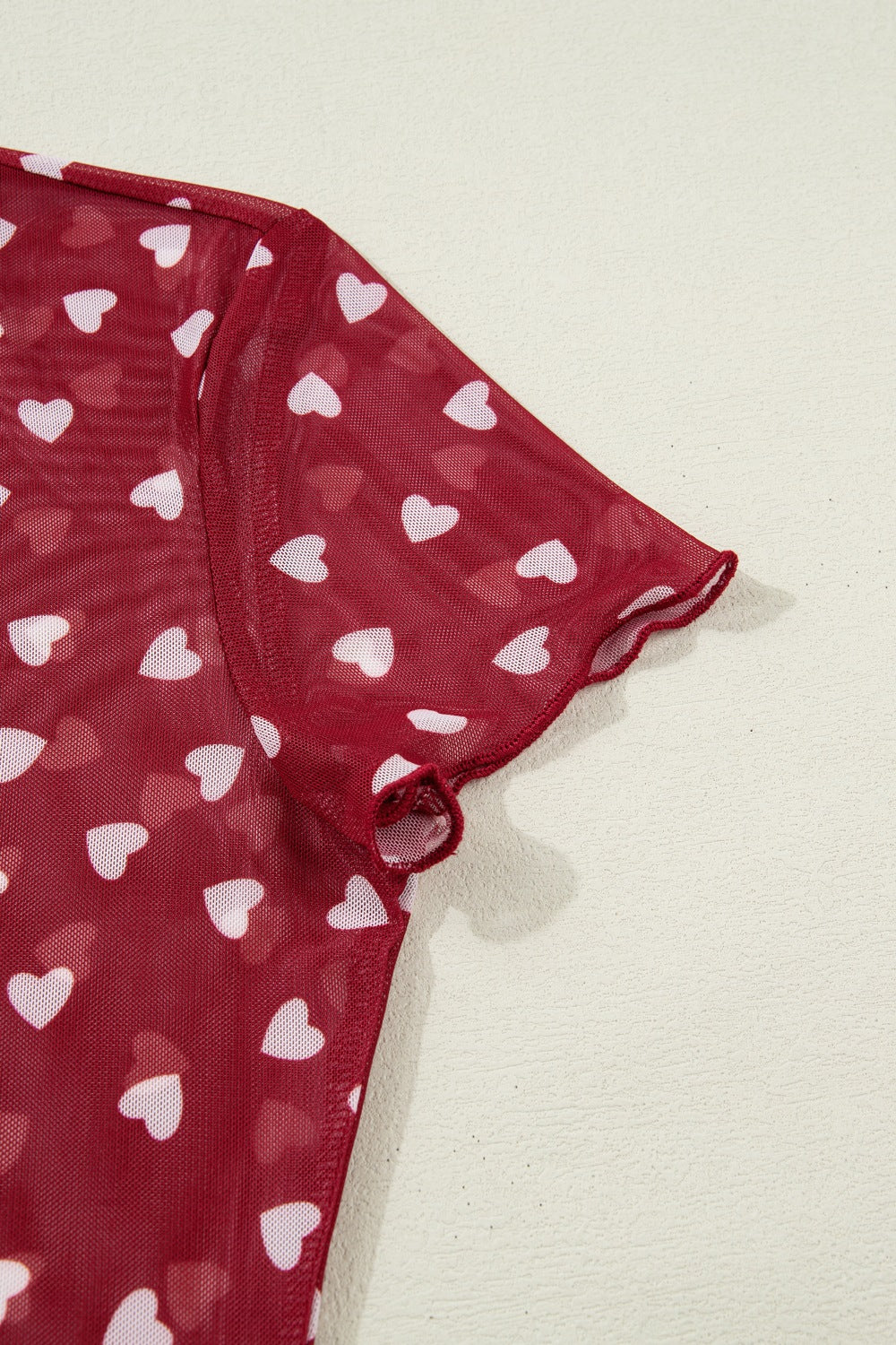 Deep Red sheer heart print t-shirt with lettuce edge sleeves.
