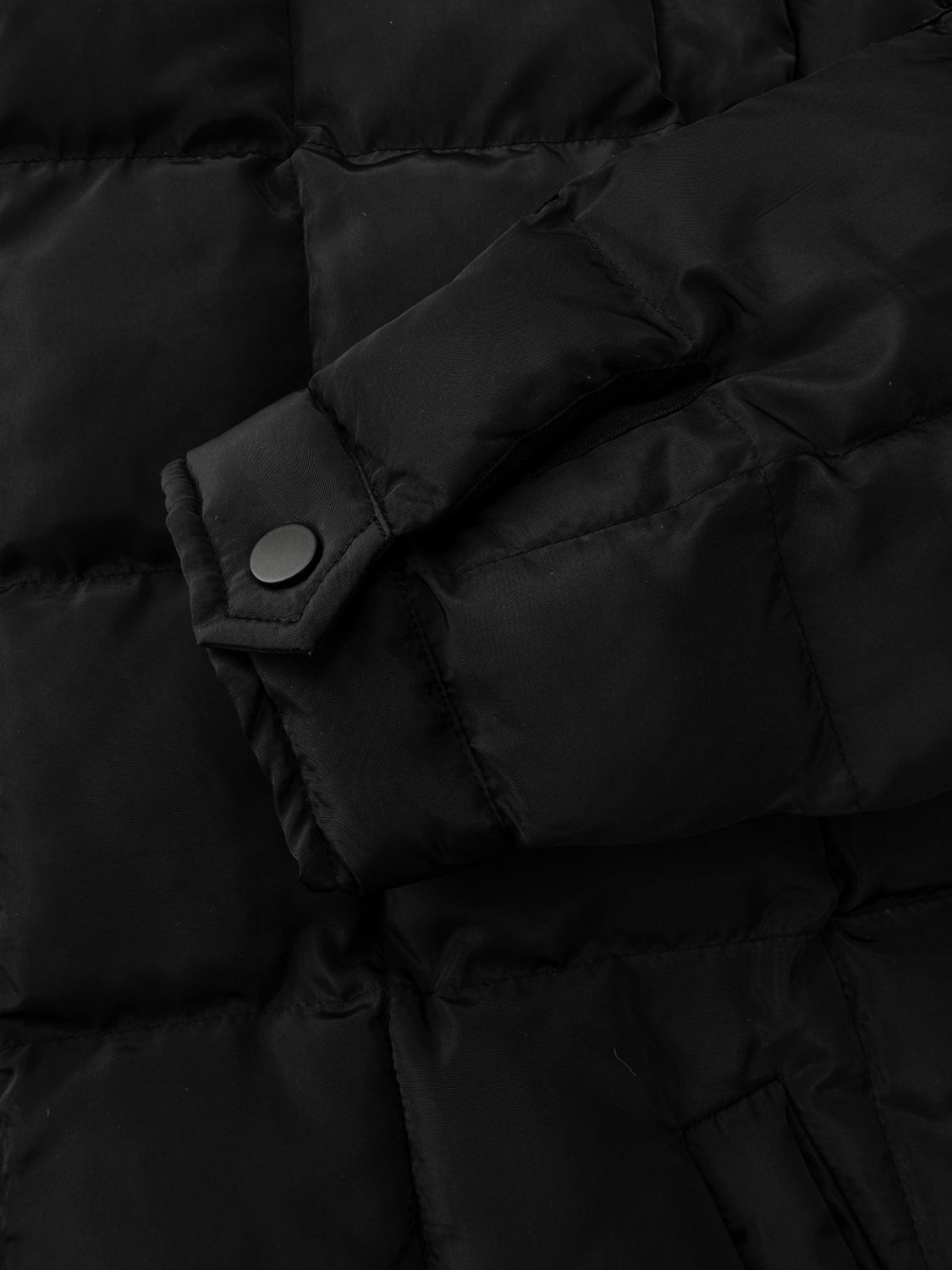 Black quilted bomber jacket with stand collar and snap cuff detail