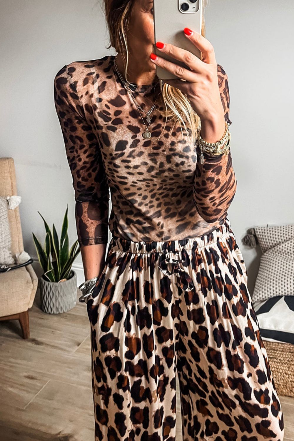 Sheer leopard print long sleeve second-skin blouse with crew neck.