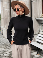 Black turtleneck knit sweater with pearl button cuffs and ribbed details.