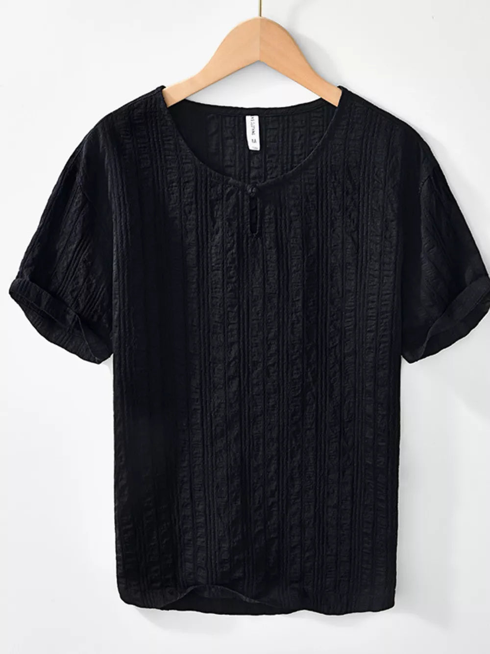 Black textured short sleeve men's blouse with button detail and rolled cuffs.