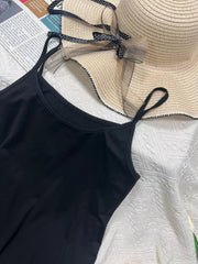Black scoop neck cami with thin straps, part of a set.