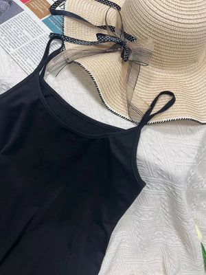 Black scoop neck cami with thin straps, part of a set.