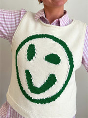 Cream knit tank top with a large green smiley face graphic.