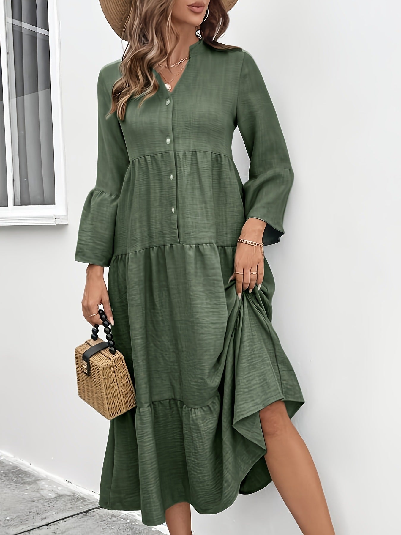 Tiered midi dress in olive green cotton blend with button front, bell sleeves, and ruffled hem.