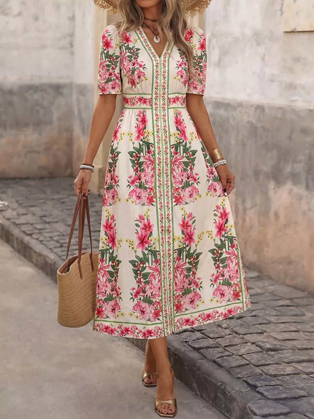 White floral midi dress with V-neck, short sleeves, and defined waist.