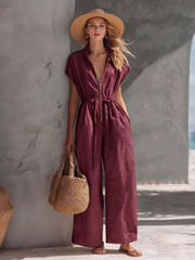 Burgundy wide-leg jumpsuit with zipper front, short sleeves, and drawstring waist.