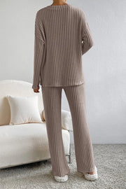 Cozy ribbed knit lounge set in tan, featuring a long sleeve top and flared pants.