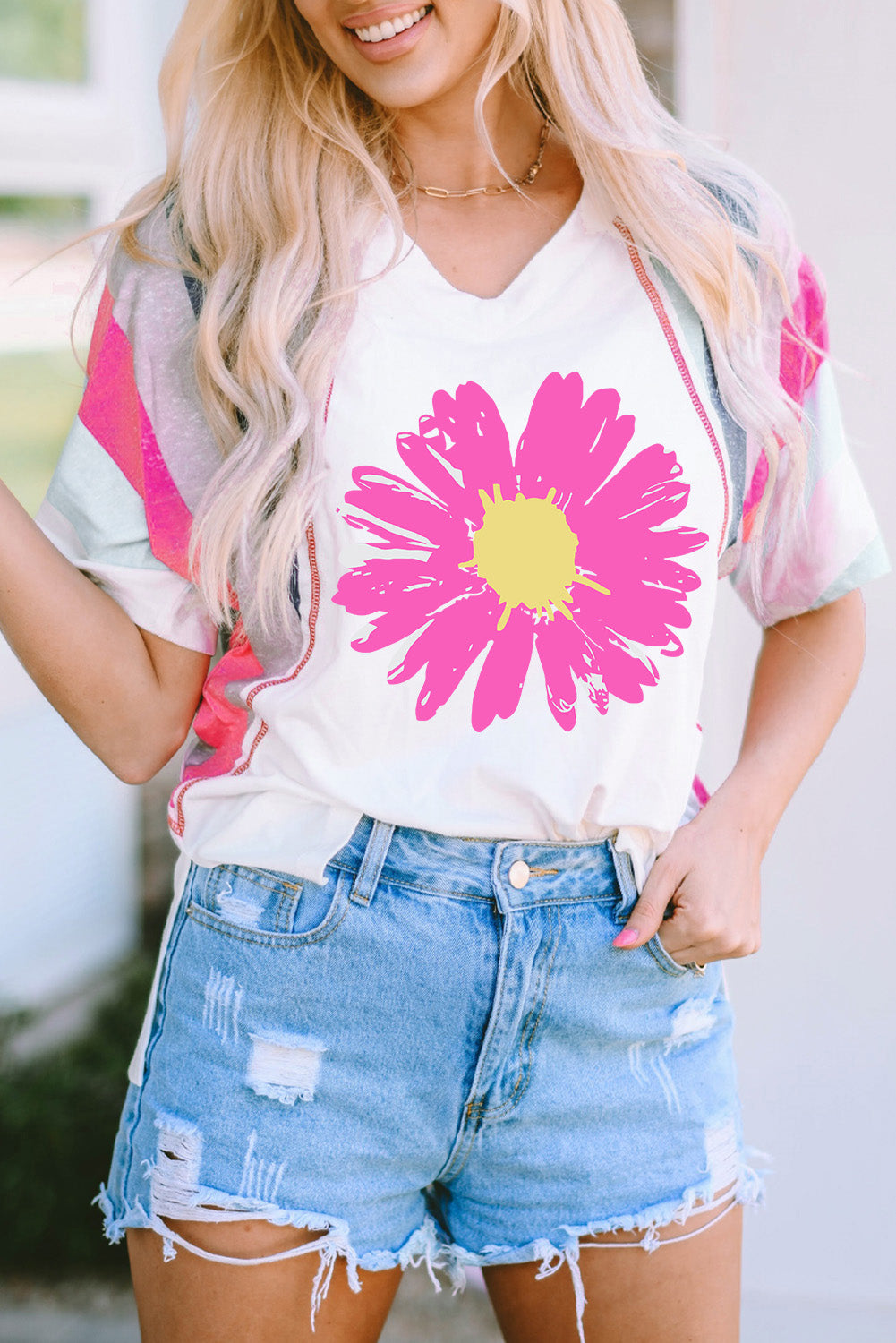 White t-shirt with large pink floral graphic and colorblock sleeves