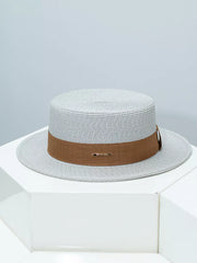 Gray straw boater hat with brown ribbon band and metal detail