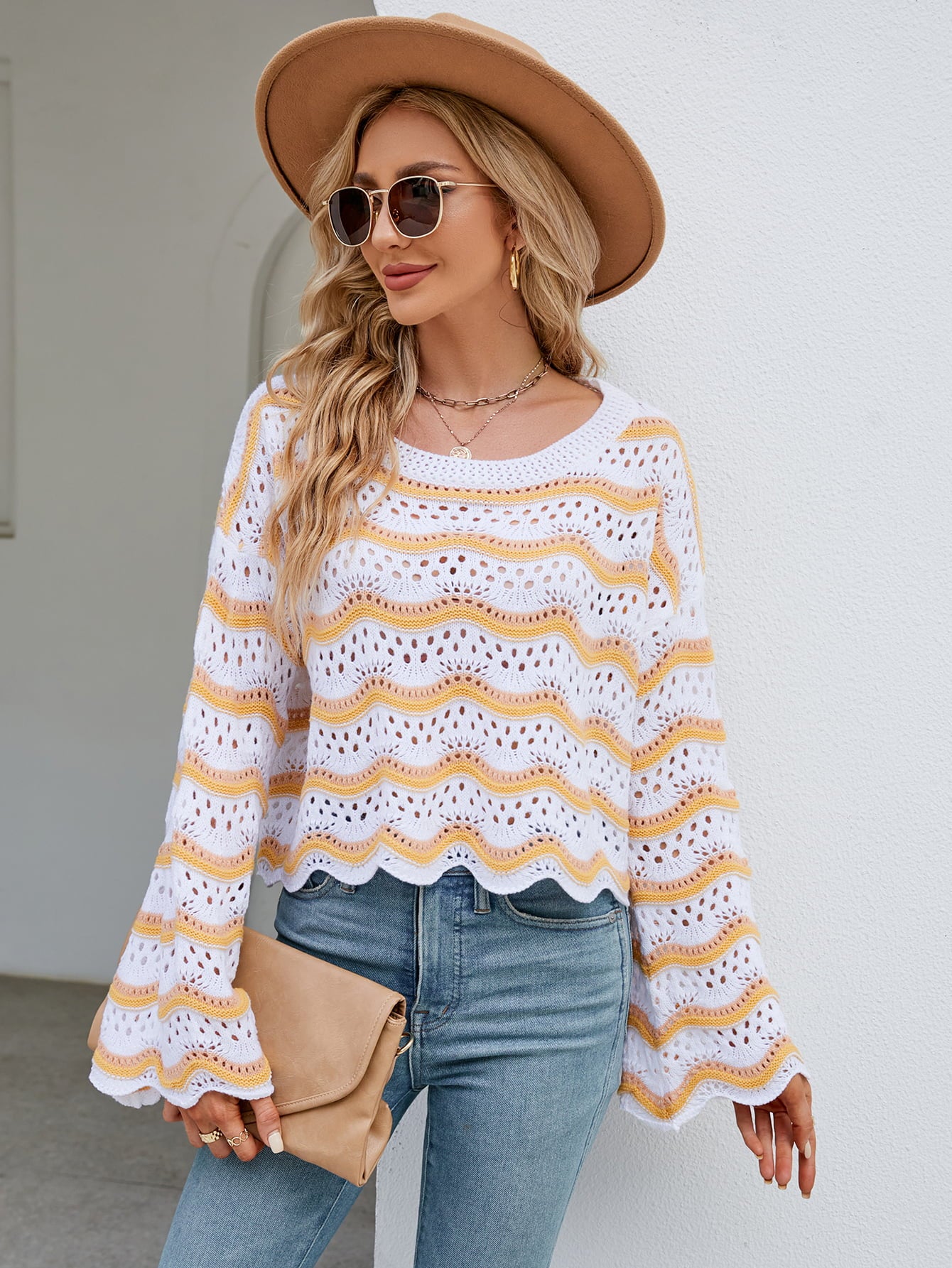Scalloped crochet crop sweater in white with yellow and orange stripes, featuring bell sleeves.