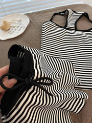 Black and white striped tank top and shorts set with drawstring detail.