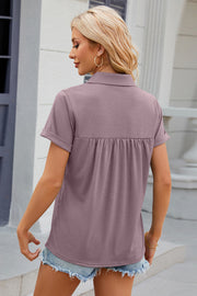 Gathered yoke polo top in lilac with short rolled sleeves and a collared neckline.