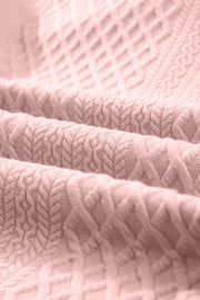 Blush pink textured trapeze dress fabric with a diamond and chevron pattern.