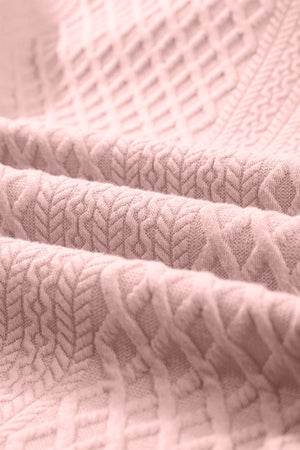Blush pink textured trapeze dress fabric with a diamond and chevron pattern.