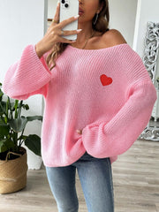 Pink slouchy boatneck knit sweater with embroidered red heart detail.