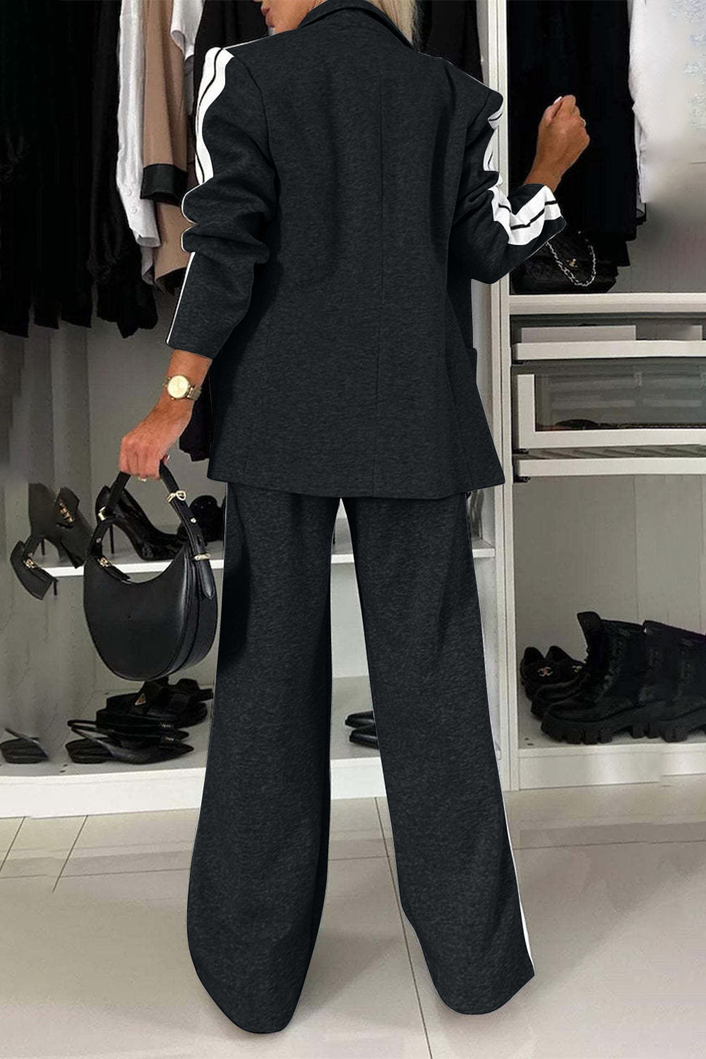 Black track stripe blazer and wide leg trouser set with white stripe details on sleeves.