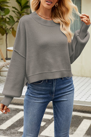 Boxy ribbed knit sweater in light gray with crew neck and balloon sleeves.
