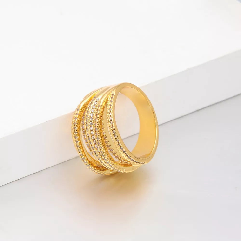Gold-plated ring with multiple rows and sparkling crystal details.