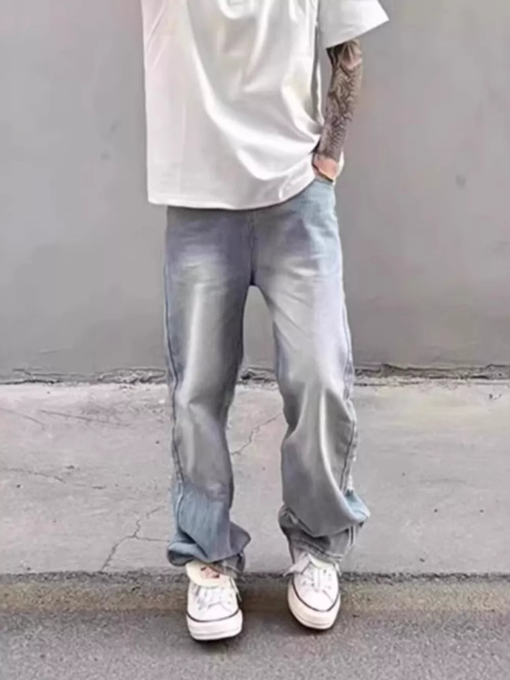 Relaxed fit light wash distressed wide leg jeans in cotton blend.