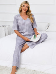 Geometric print V-neck lounge set in cloudy blue with short sleeves and full-length pants.