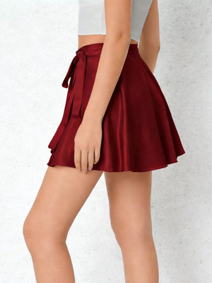 Chic red satin tie-side flared mini skirt with a flattering silhouette.