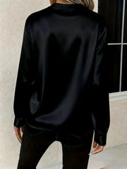 Black satin long sleeve blouse with a notched neckline, shown from the back.